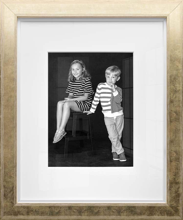 Black and white portrait of brother and sister framed in gold