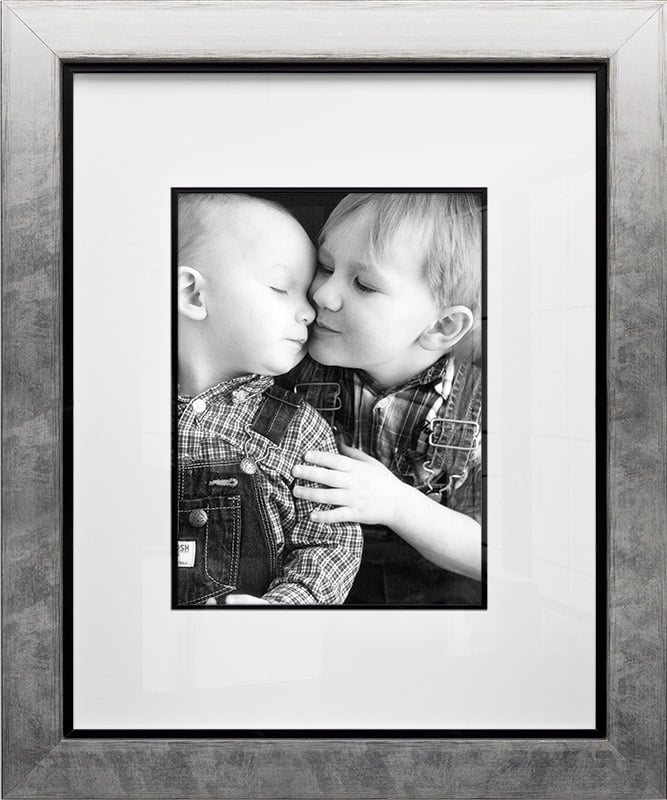 Black and white portrait of two young brothers hugging framed in silver